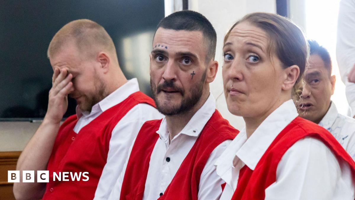Phineas Float, Jon Collyer and Lisa Stocker (left to right) are accused of drug offences in Bali. They are wearing distinctive white and red prison uniforms. Collyer has facial tattoos.