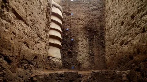 Tamil Nadu State Department of Archaeology A terracota ringwell embedded in the soil in Keeladi in Tamil Nadu, India