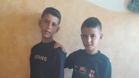 Family handout Iman al-Nouri's son Omar (right) and one of his elder brothers