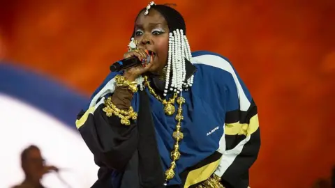 Getty Images Lauryn Hill performing in a blue jacket during Drake's set