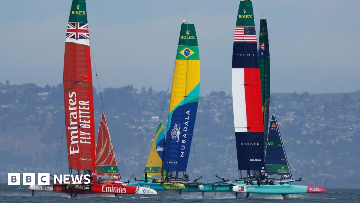 The Great Britain SailGP team race against the Brazil SailGP team and the United States SailGP team on the water