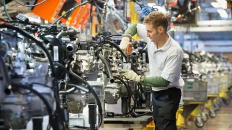 Getty Images Man working on a car engine