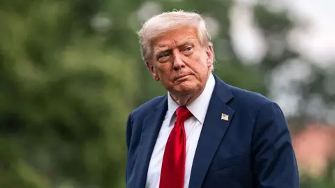 Getty Images US President Donald Trump wearing a navy blue suit, white shirt and red tie