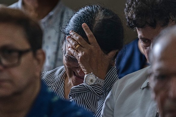 The mother of Clive Kunder, co-pilot of the Air India flight that crashed, mourns during a prayer meeting for Air India crew in Mumbai.