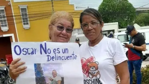 Courtesy of Gertrudis Pineda Gertrudis Pineda holds up a sign with a photo of her son, reading: "Oscar is not a criminal." 