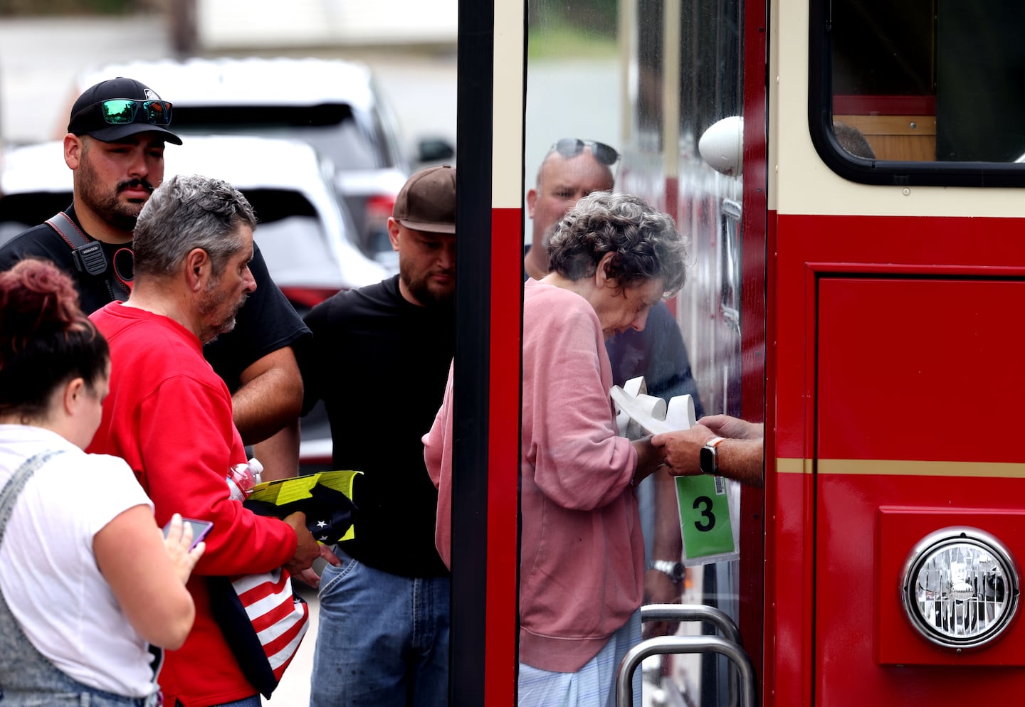 Officials help residents who survived a fire that killed 9 people at the Gabriel House Assisted Living Facility onto a trolley which will move them to another place where they can stay in Fall River, MA on July 14, 2025.
