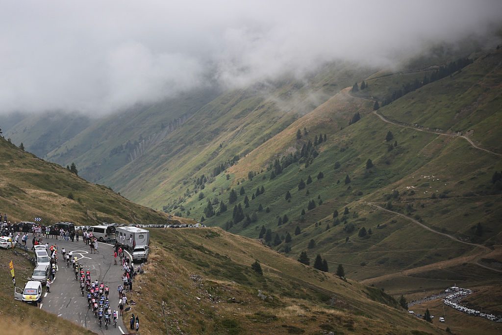 A group of riders cycle in the ascent of Col du Tourmalet during the 14th stage of the 112th edition of the Tour de France cycling race, 182.6 km between Pau and Luchon-Superbagneres, in the Pyrenees mountains of southwestern France, on July 19, 2025. (Photo by Anne-Christine POUJOULAT / AFP)