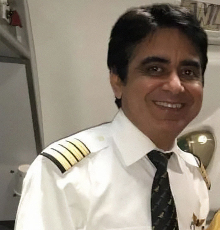 Air India pilot smiling in uniform with captain stripes highlighting personal turmoil before crash incident
