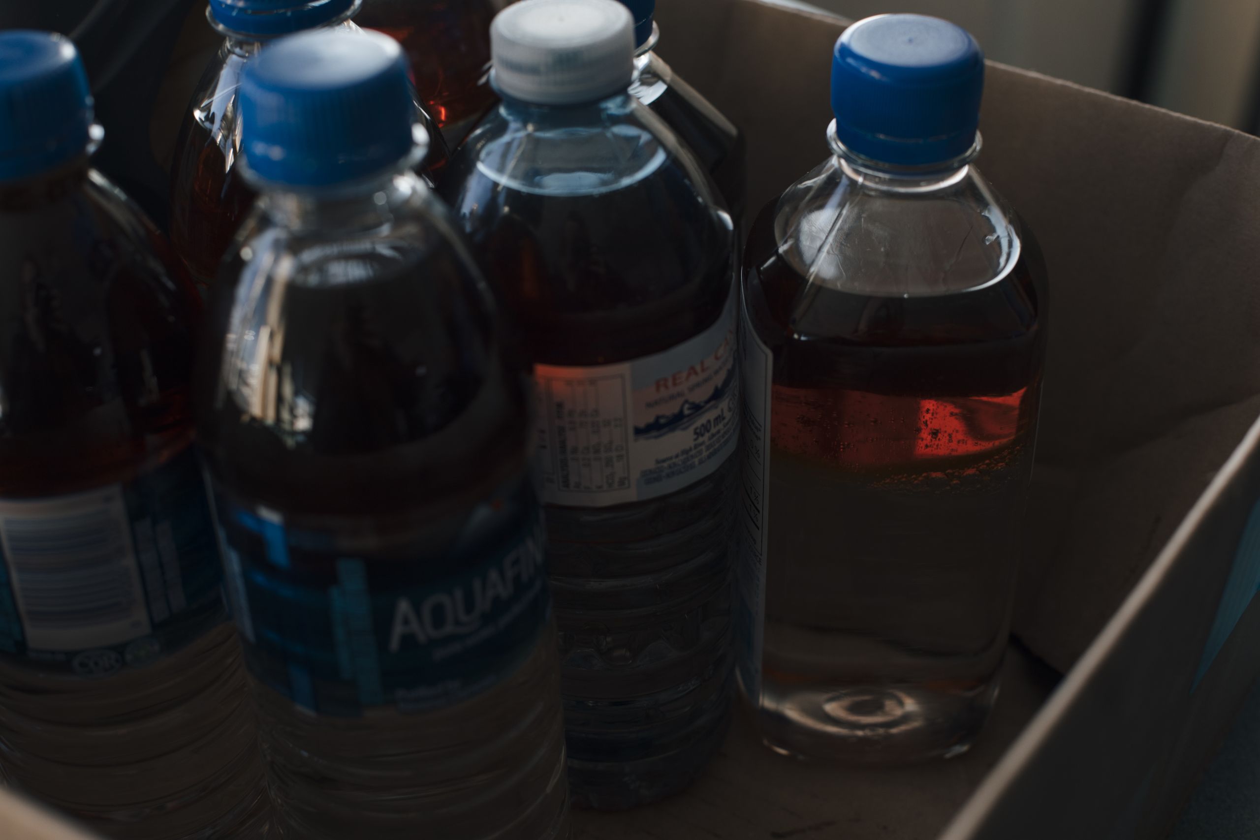 plastic water bottles partially filled with water and oil.