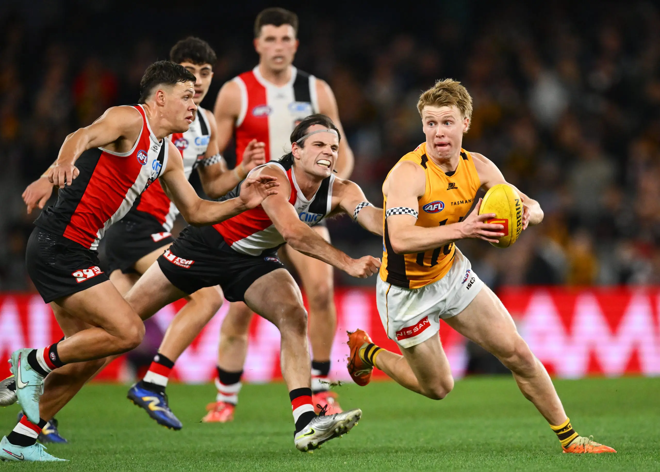 MELBOURNE, AUSTRALIA - JULY 05: Cam Mackenzie of the Hawks runs with the ball under pressure from Hunter Clark of the Saints during the round 17 AFL match between St Kilda Saints and Hawthorn Hawks at Marvel Stadium on July 05, 2025 in Melbourne, Australia. (Photo by Quinn Rooney/Getty Images)
