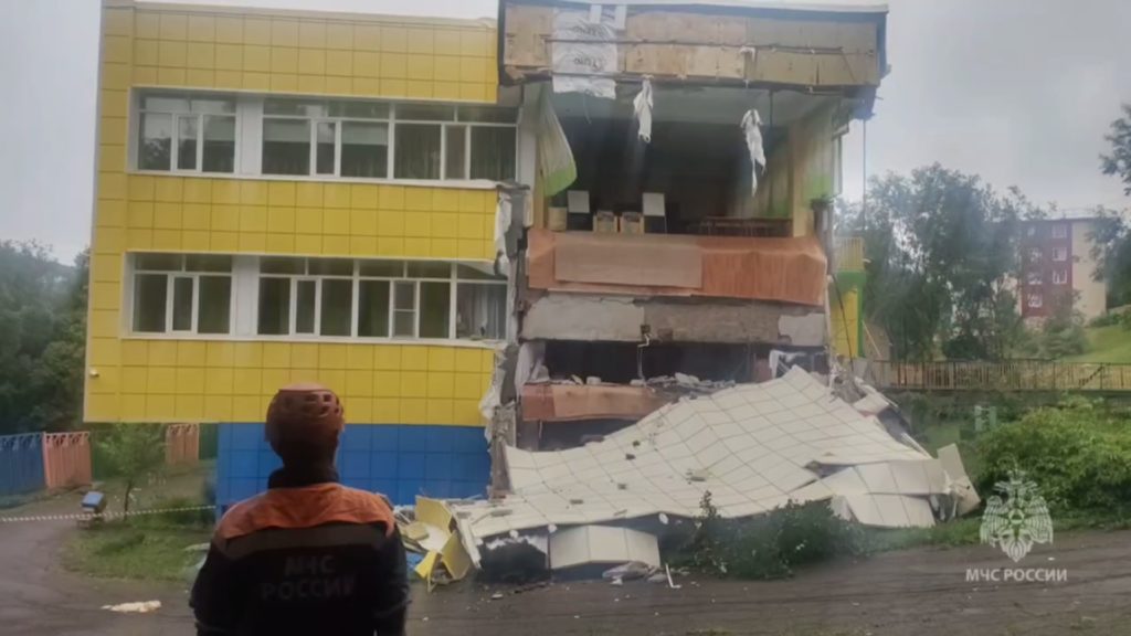 A screen grab from a video shows rescuers of the Ministry of Emergency Situations of Russia inspecting a damaged building ...