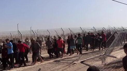 Israel faces claims of firing on civilians; reservist says mob tried to overrun aid c