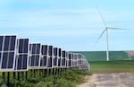 FILE - The bill also adds new fees for solar and wind projects on Forest Service and Bureau of Land Management land, and it introduces new taxes on the energy generated by those projects. Solar panels and wind turbines work to create clean electric power, at Wheatridge Renewable Energy Facility in this May 24, 2022 file photo.