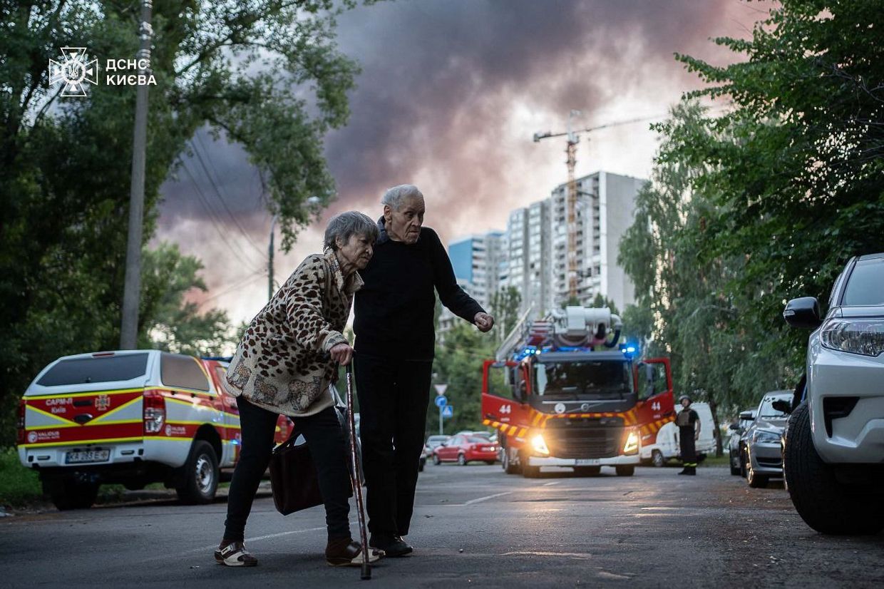 Flames and smoke billow from buildings in Kyiv, Ukraine, on July 4, 2025, during mass Russian drone and missile strikes.