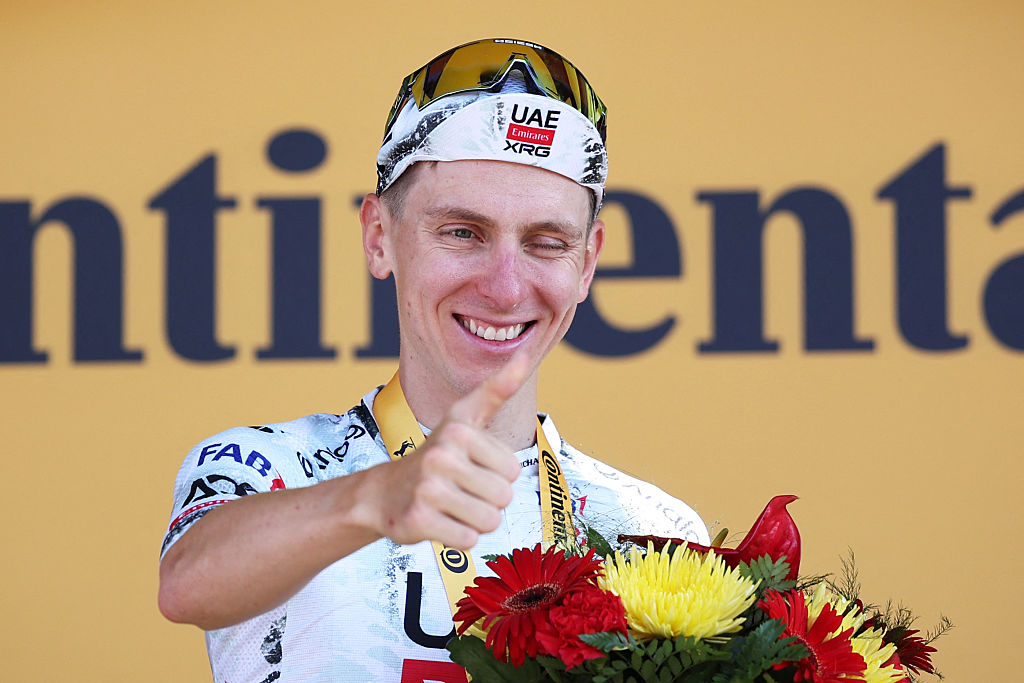 UAE Team Emirates - XRG team's Slovenian rider Tadej Pogacar celebrates on the podium after winning the 13th stage of the 112th edition of the Tour de France cycling race, 10.9 km individual time trial between Loudenvielle and Peyragudes, in the Pyrenees mountains of southwestern France, on July 18, 2025. (Photo by Anne-Christine POUJOULAT / AFP)
