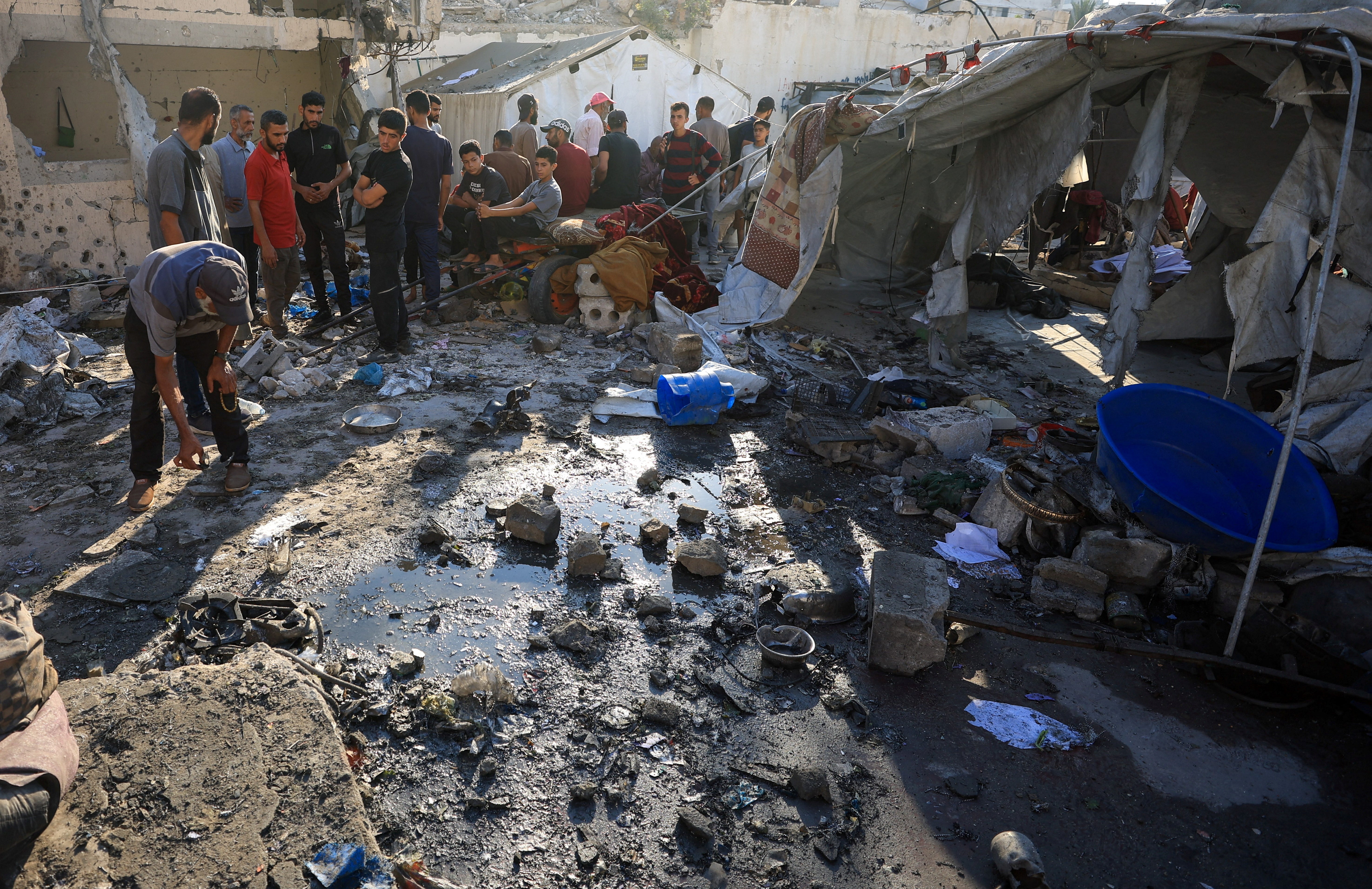 Palestinians inspect the damage at the site of an overnight Israeli strike on a tent sheltering displaced people, in Gaza City, July 24, 2025. REUTERS/Dawoud Abu Alkas gazawrap