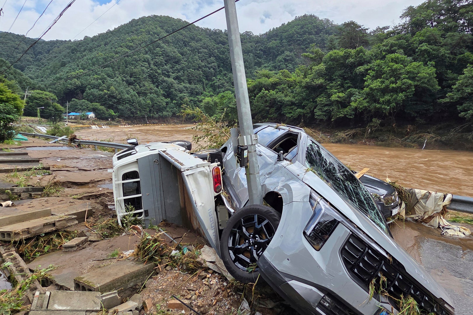 Damaged vehicles are seen after heavy rainfall in Gapyeong, South Korea, on 20 July 2025