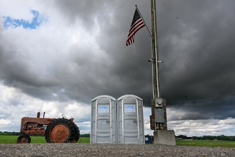 Storm clouds bring rain to a produce stand in Elmer, N.J., on Sunday; expect a rinse, repeat Monday.
