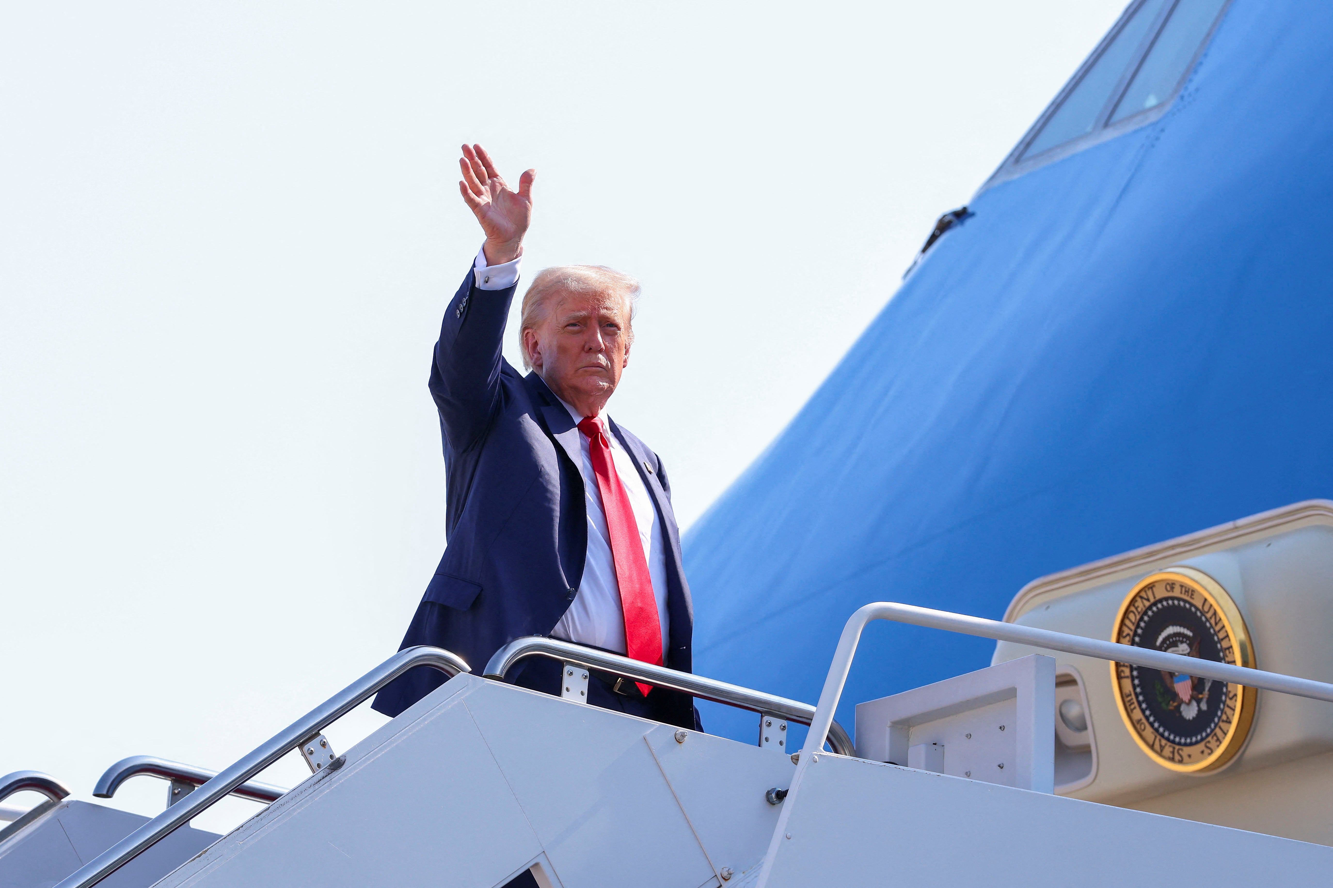 U.S. President Donald Trump waves as he boards Air Force One, as he departs for Scotland, at Joint Base Andrews, Maryland, U.S., July 25, 2025. REUTERS/Evelyn Hockstein