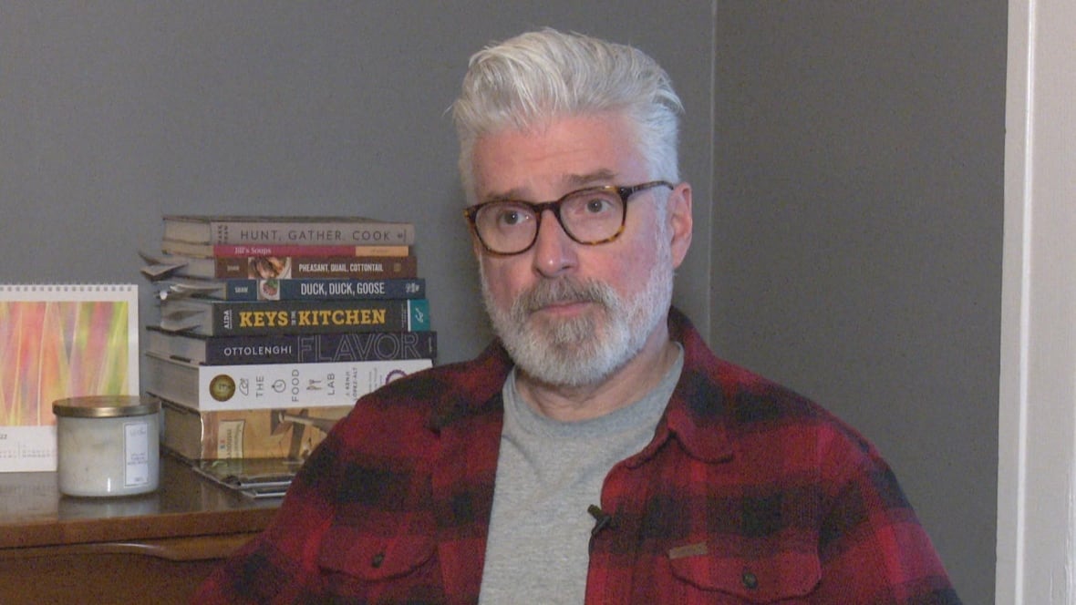 A man wearing a striped shirt is pictured.