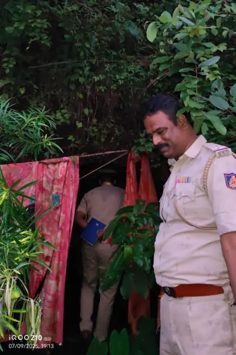 Karnataka police Policemen stand outside the cave in Gokarna forest
