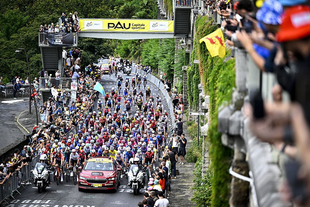 The peloton pictured underneath the Pau banner at the start of stage 14 of the 2025 Tour de France cycling race, from Pau to Luchon-Superbagneres (183 km), on Saturday 19 July 2025 in France. The 112th edition of the Tour de France starts on Saturday 5 July in Lille, France, and will finish in Paris, France on the 27th of July. BELGA PHOTO JASPER JACOBS (Photo by JASPER JACOBS / BELGA MAG / Belga via AFP)