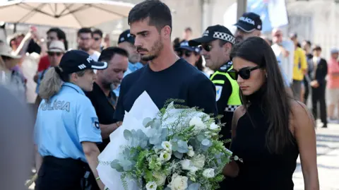 PA Media Andre Silva, football player at RB Leipzig and the Portuguese national team, and partner Maria Rodrigues attend a public wake held for Diogo Jota and his brother Andre Silva at the Capela da Ressurreicao. 