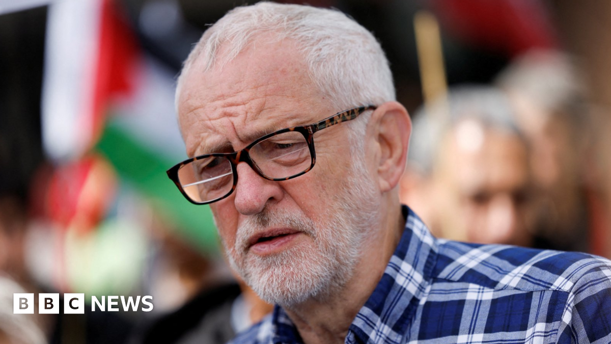 Independent MP Jeremy Corbyn wearing a blue plaid shirt and tortoiseshell glasses