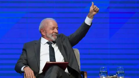 Getty Images Luiz Inácio Lula da Silva holds a thumbs-up gesture