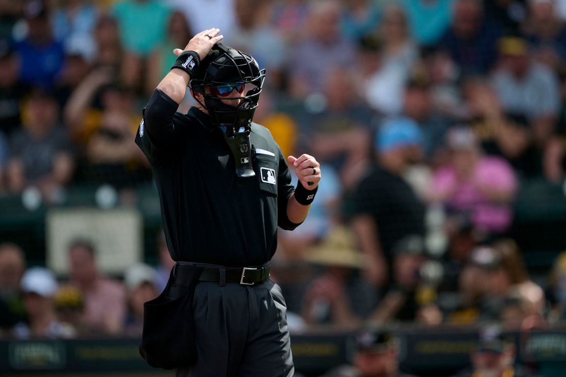 Home plate umpire Ryan Wills calls for a pitch review from the Automated Ball-Strike System during a spring training baseball game between the Boston Red Sox and Pittsburgh Pirates.