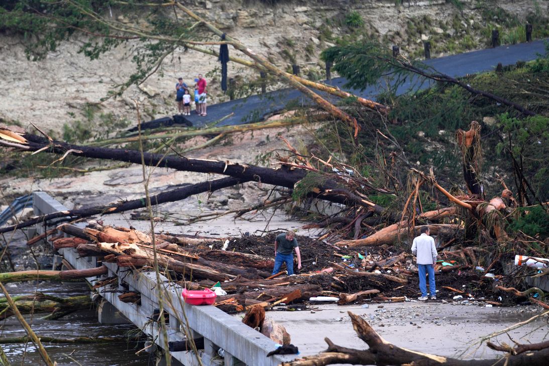 Massive debris impale a bridge over the Guadalupe River on Saturday in Ingram, Texas.