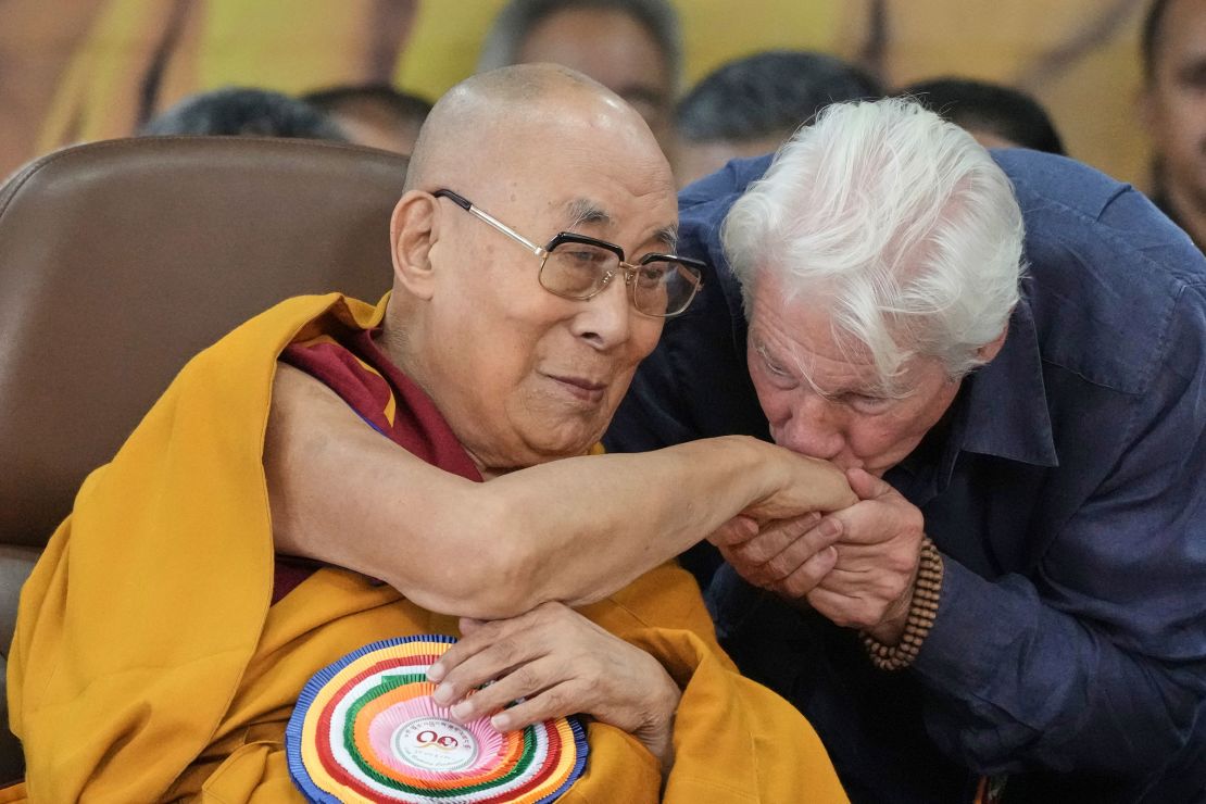 Actor Richard Gere, right, kisses the the Dalai Lama's hand at an event celebrating his 90th birthday in Dharamshala, India, on Sunday.