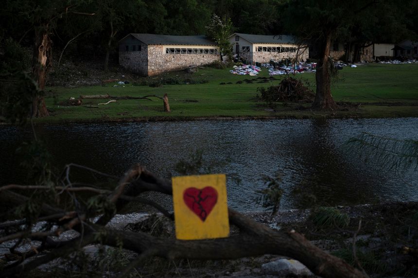 A broken heart sign is displayed near Camp Mystic on July 8.