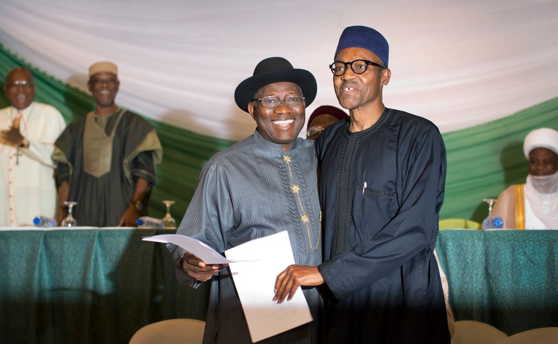 Nigeria's former president Goodluck Jonathan, left, and then-opposition candidate Muhammadu Buhari, hug after signing a renewal of their pledge to hold peaceful elections, at a hotel in the capital Abuja, Nigeria on March 26, 2015.