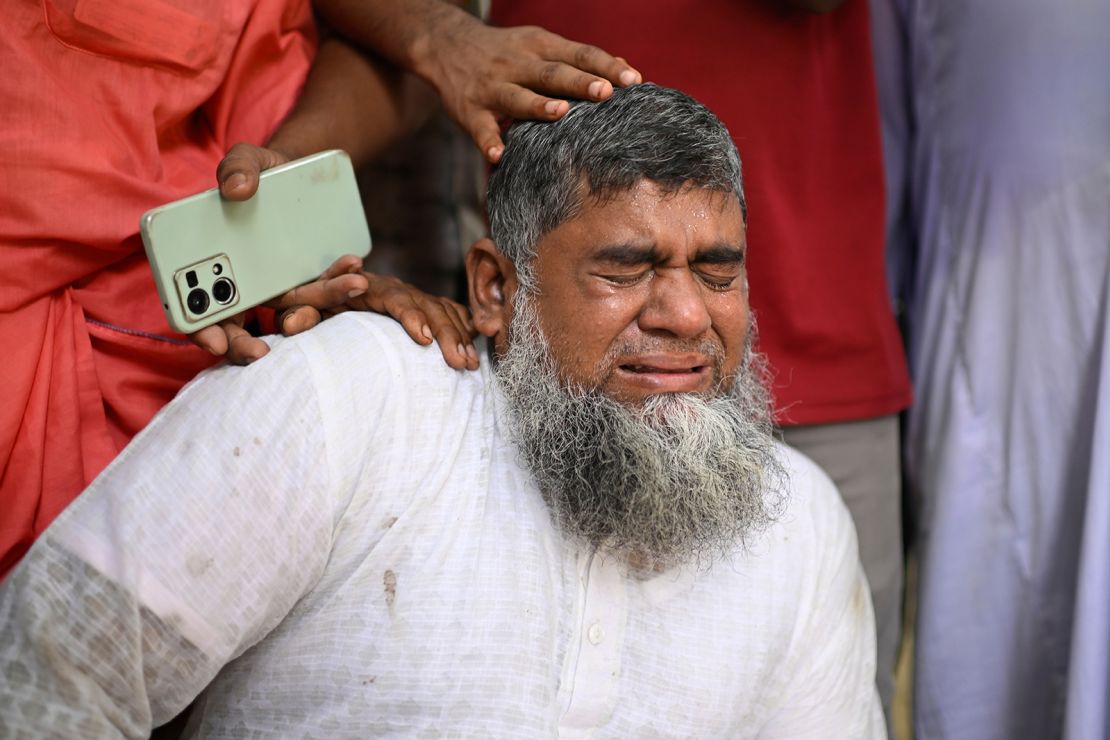 Shahbul, the father of a missing girl, cries after a Bangladesh Air Force training aircraft crashed into a school campus in Dhaka, Bangladesh.