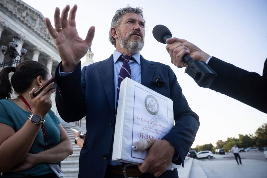 Rep. Thomas Massie holds a copy of a bill he cosponsored with Democratic Rep. Ro Khanna to force the House to vote on the complete release of the Jeffrey Epstein files, on Monday.