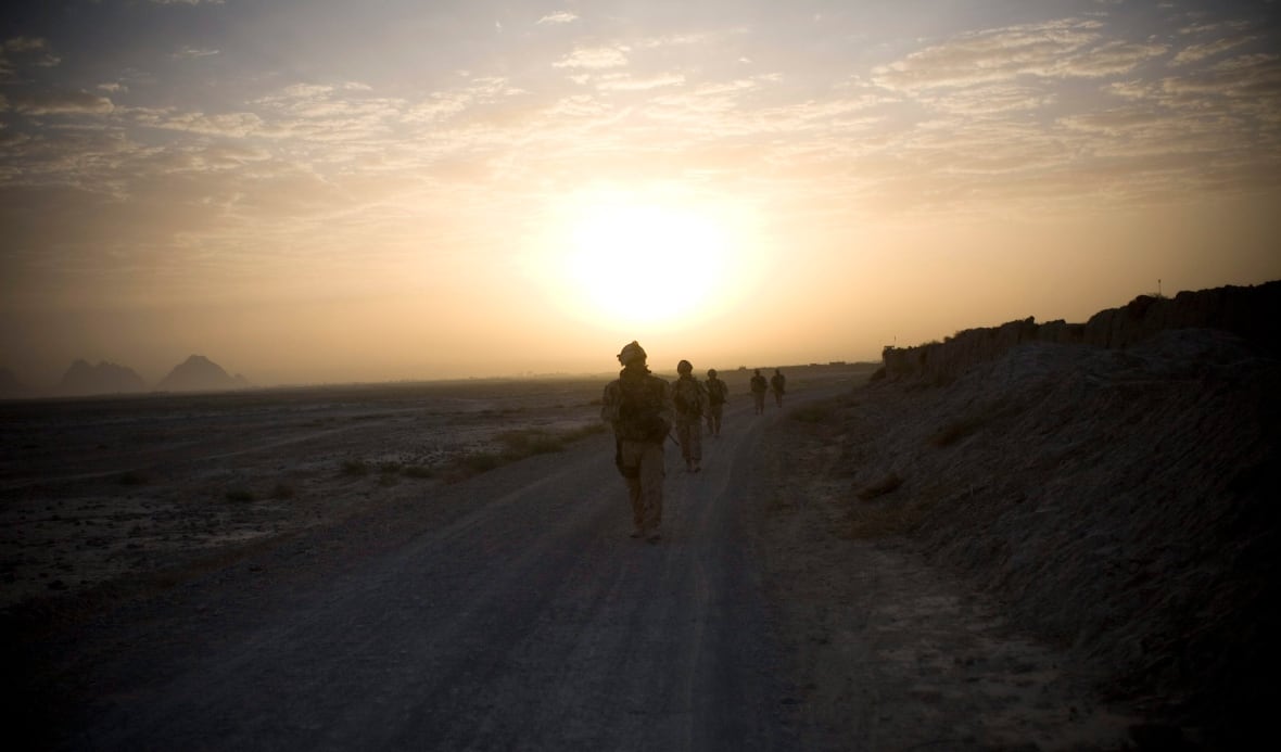 In this photo taken Saturday, Sept. 11, 2010, Canadian soldiers with the 1st RCR Battle Group, The Royal Canadian Regiment, patrol in the early morning outside Salavat, southwest of Kandahar, Afghanistan.