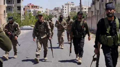Reuters Syrian security forces patrol the southern city of Suweida. Photo: 17 July 2025