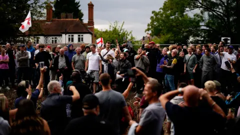 PA Media A large group of people. There are two St George's flags in the shot.