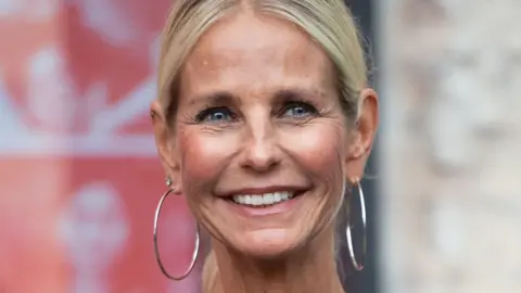 Getty Images Ulrika Jonsson smiling and wearing large hoop earrings in 2021