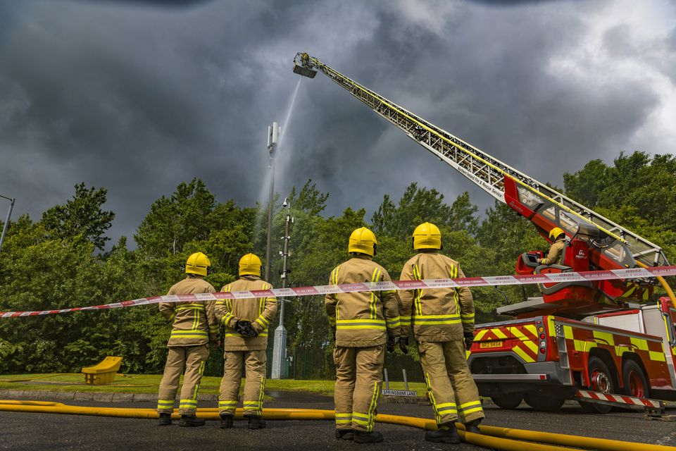 Firefighters battle a fire at a 5g mast in the Springbank Industrial Estate in Poleglass