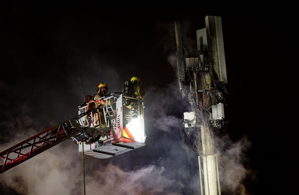 Firefighters deal with a 5G mast fire at Distillery Street in west Belfast