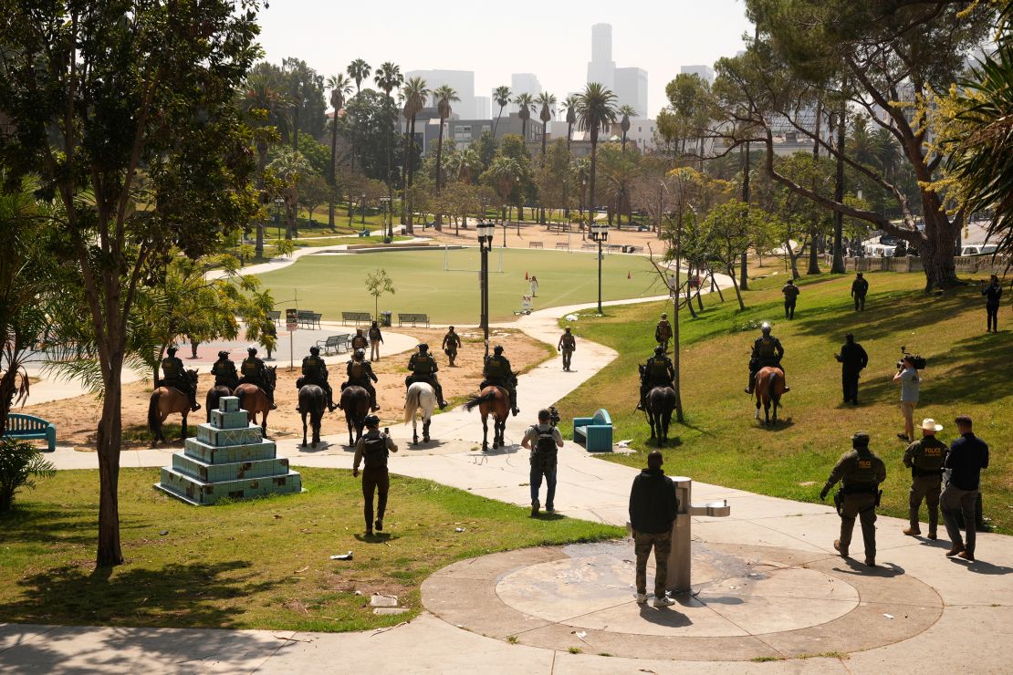 Federal agents ride on horseback at MacArthur Park on July 7 in Los Angeles.