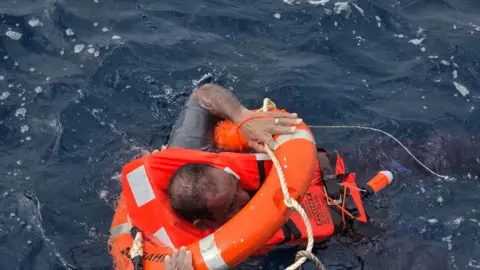 Diaplous/Handout via Reuters A crew member said to be from the cargo ship Eternity C, which sank after being attacked by the Houthis, is seen in the Red Sea during a rescue operation in this handout image released Greece-based maritime security firm Diaplous on 9 July 2025