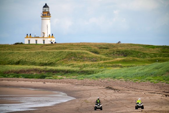 Police patrol the beach at Turnberry golf course.