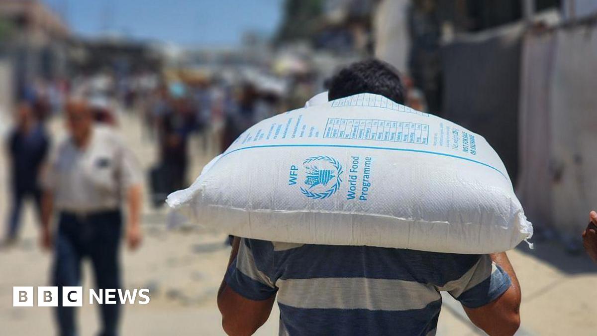 A woman holds a severely underweight child in a tent in Gaza