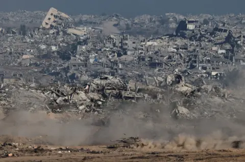 Reuters An Israeli tank moves in Gaza, as seen from the Israeli side of the border (6 July 2025)
