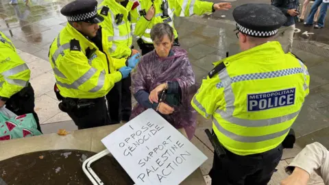 BBC Police arrest a woman in Parliament Square, London