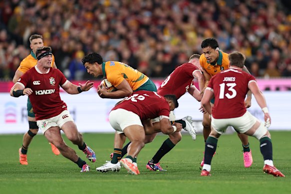 Joseph-Aukuso Suaalii of the Wallabies is tackled during the Lions match over the weekend.