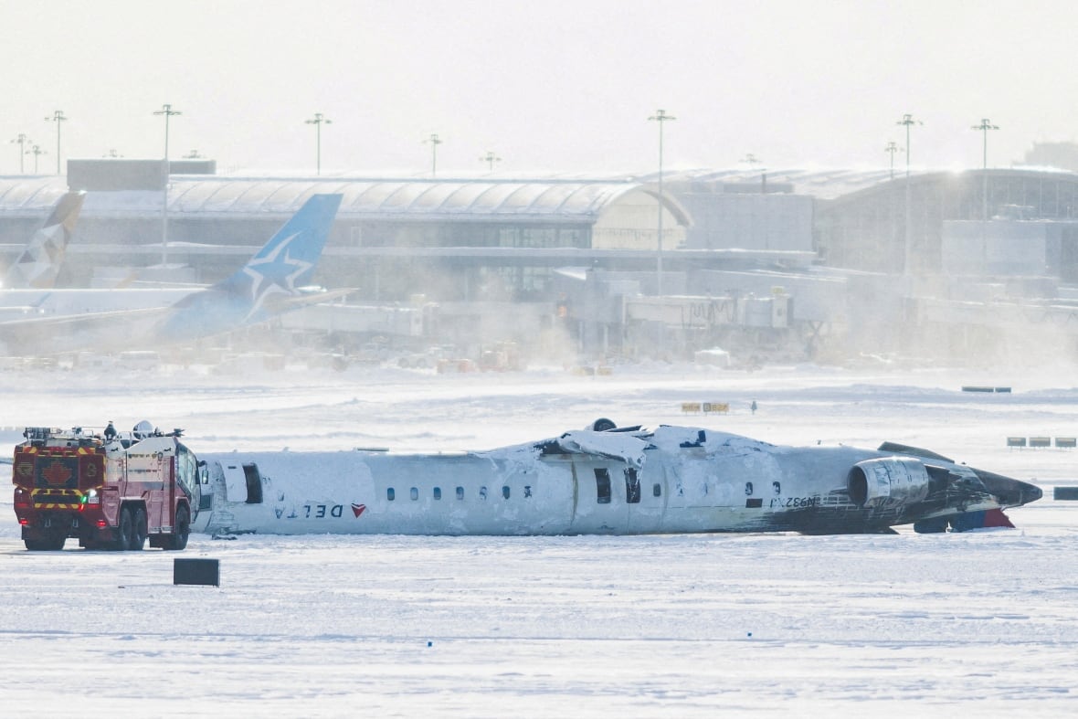A crashed passenger jet on a snowy runway.